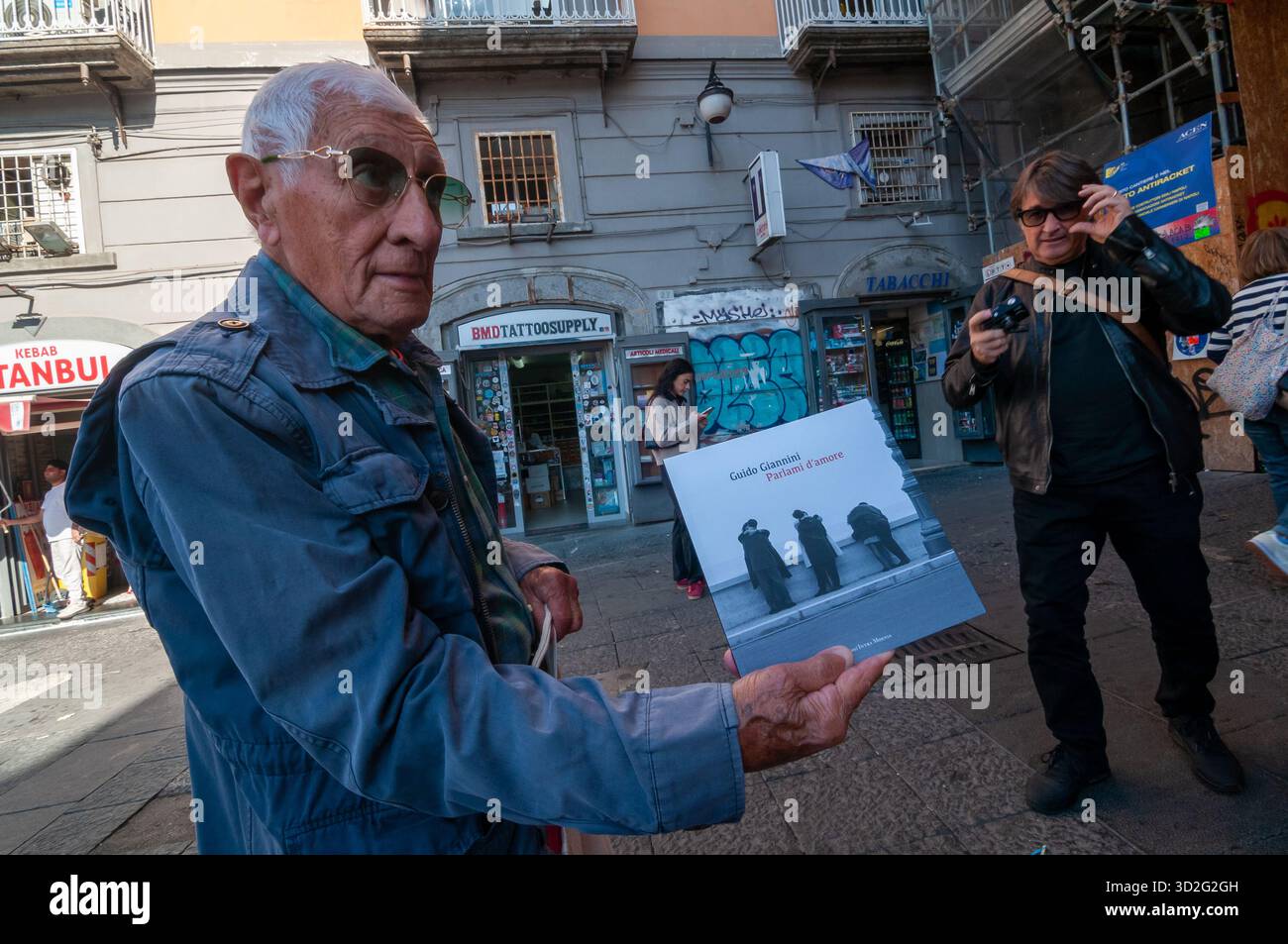 Photographer Guido Giannini, over ninety, shows off his latest book. Naples Stock Photo