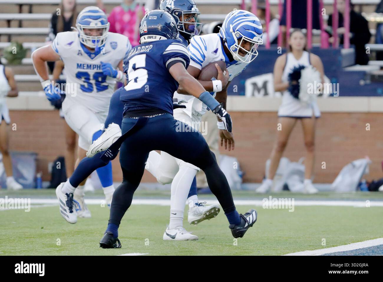 Memphis quarterback Brendon Lewis, right, gets past Rice cornerback ...