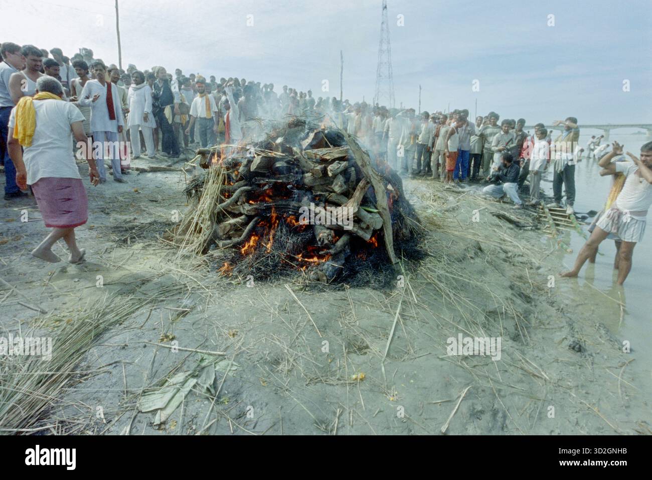 A Hindu priest lights the funeral pyre of a protester killed in violent ...