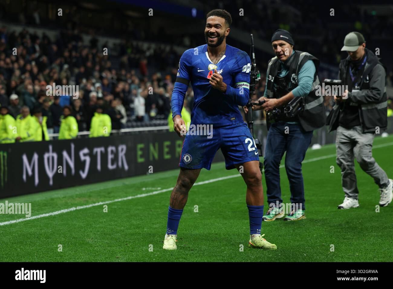 Chelsea captain Reece James points at the badge on his shirt and ...