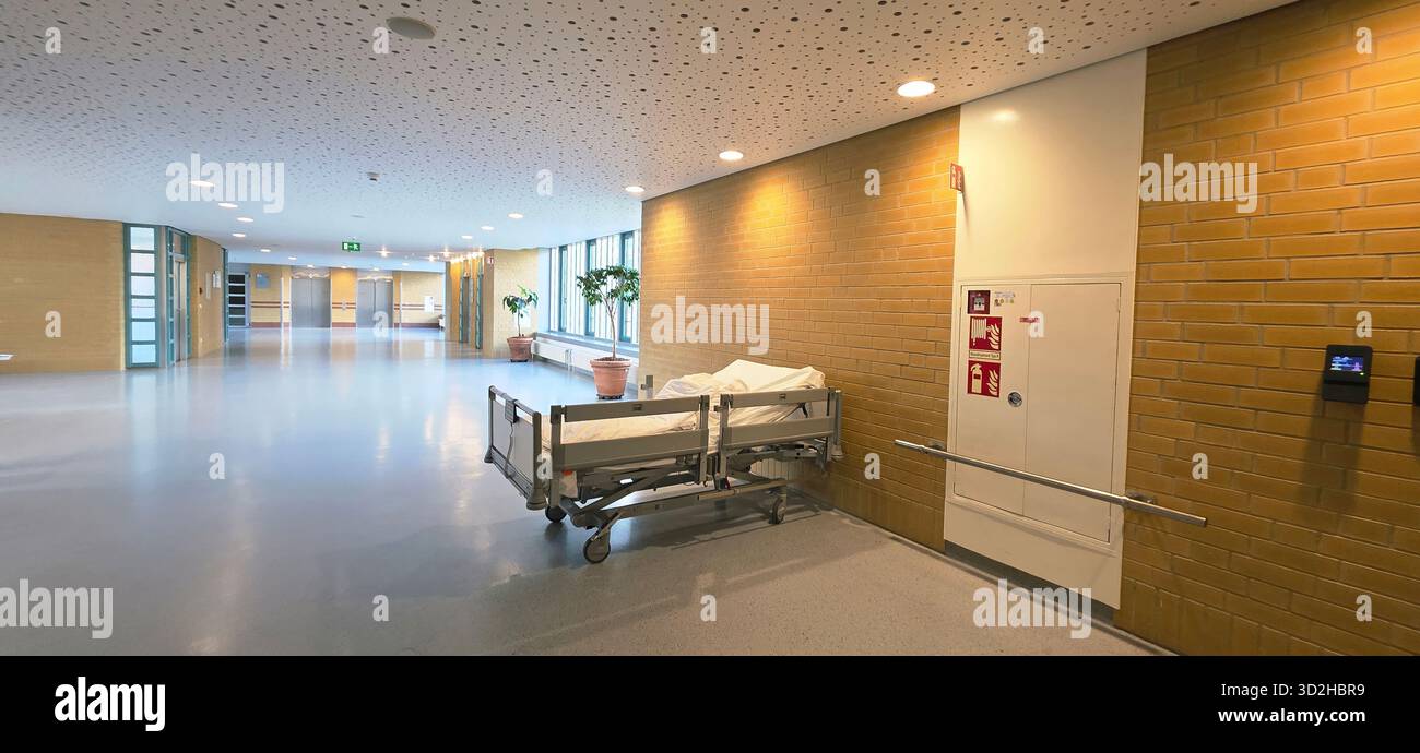 Belin, Germany - May 30, 2025: Hospital corridor features an empty bed, bright lighting, and clean modern design. Hospital - Smartphone Captured Stock Image