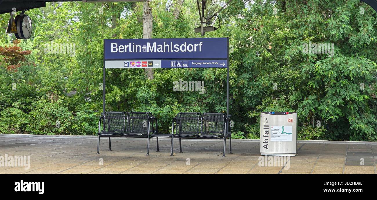 Berlin, Germany - July 03, 2025: . Berlin-Mahlsdorf train station features benches and lush green foliage nearby - Smartphone Captured Stock Image