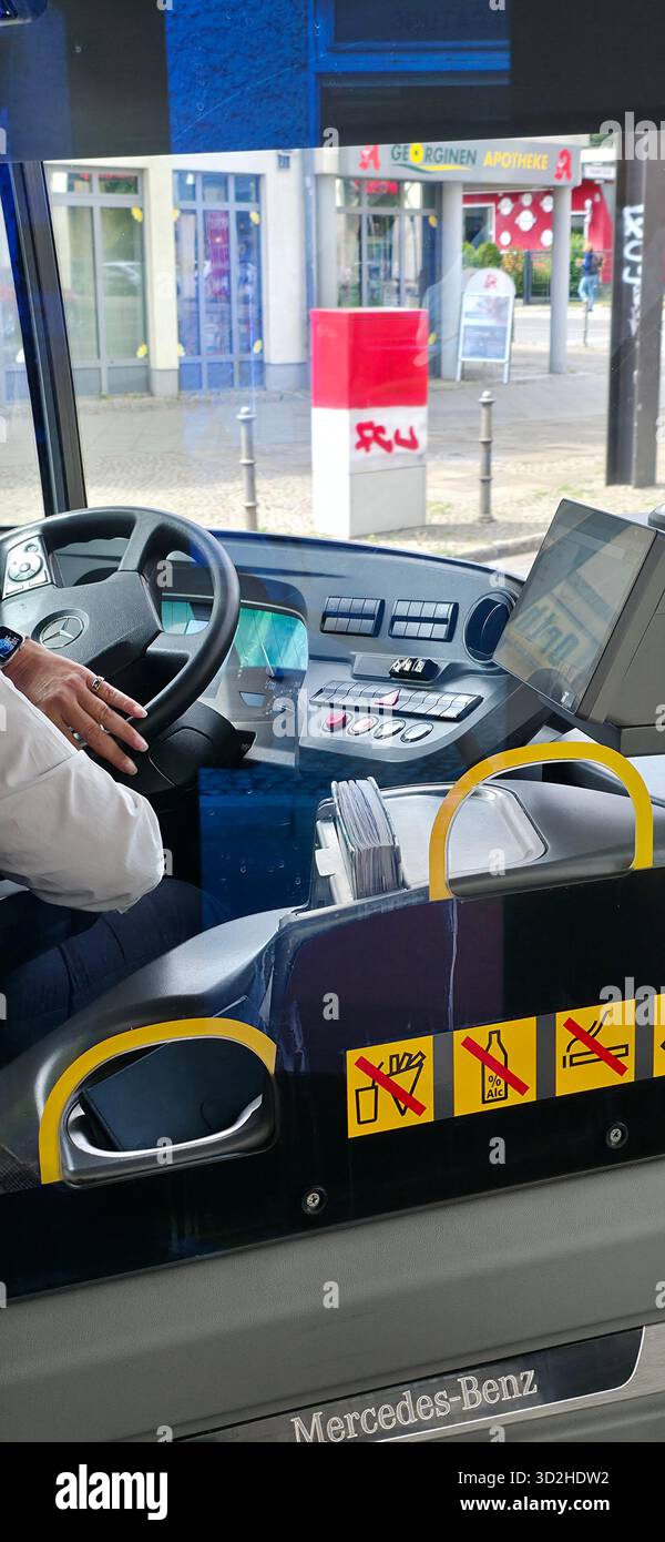Berlin, Germany - August 07, 2025: Mercedes-Benz bus interior shows driver operating controls and dashboard features. - Smartphone Captured Stock Image
