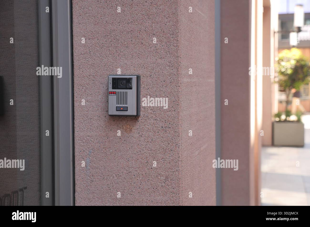 Modern intercom system installed on a smooth concrete wall Stock Photo