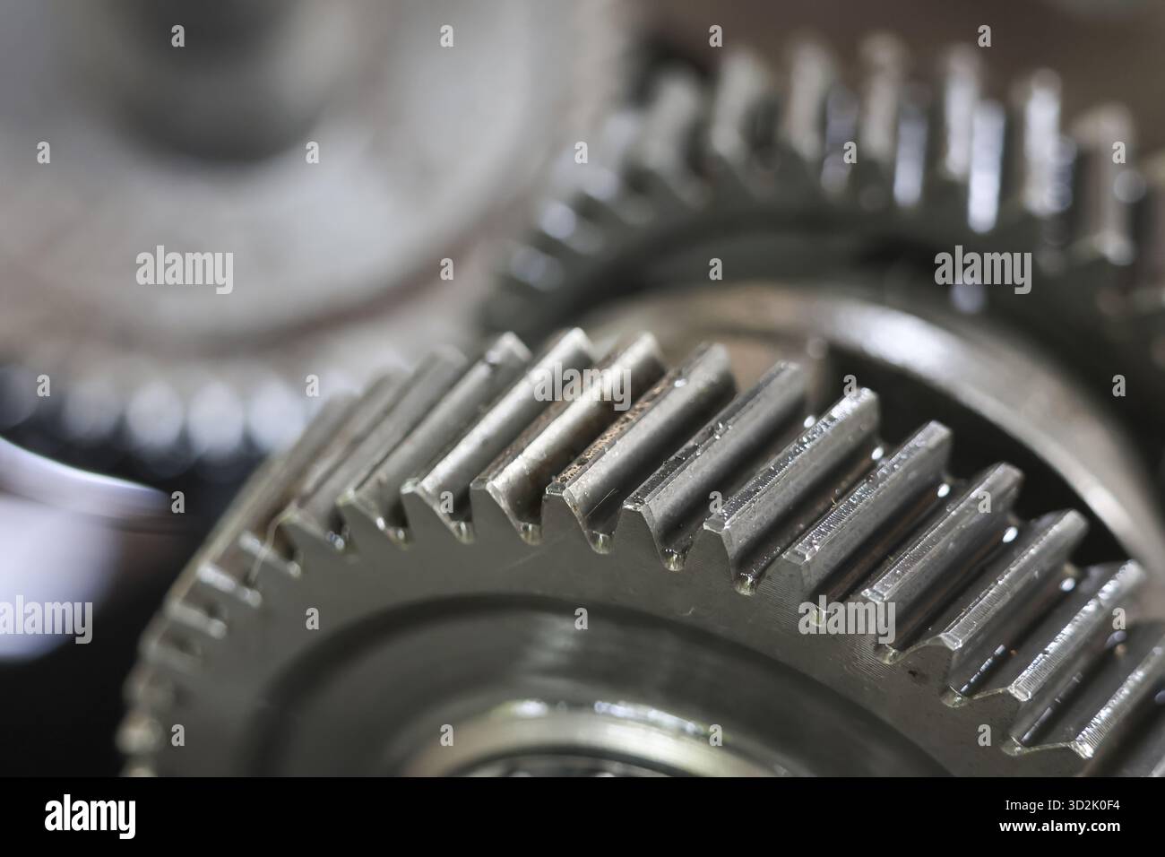 Close up of interlocking metal gears showing complex mechanical system ...