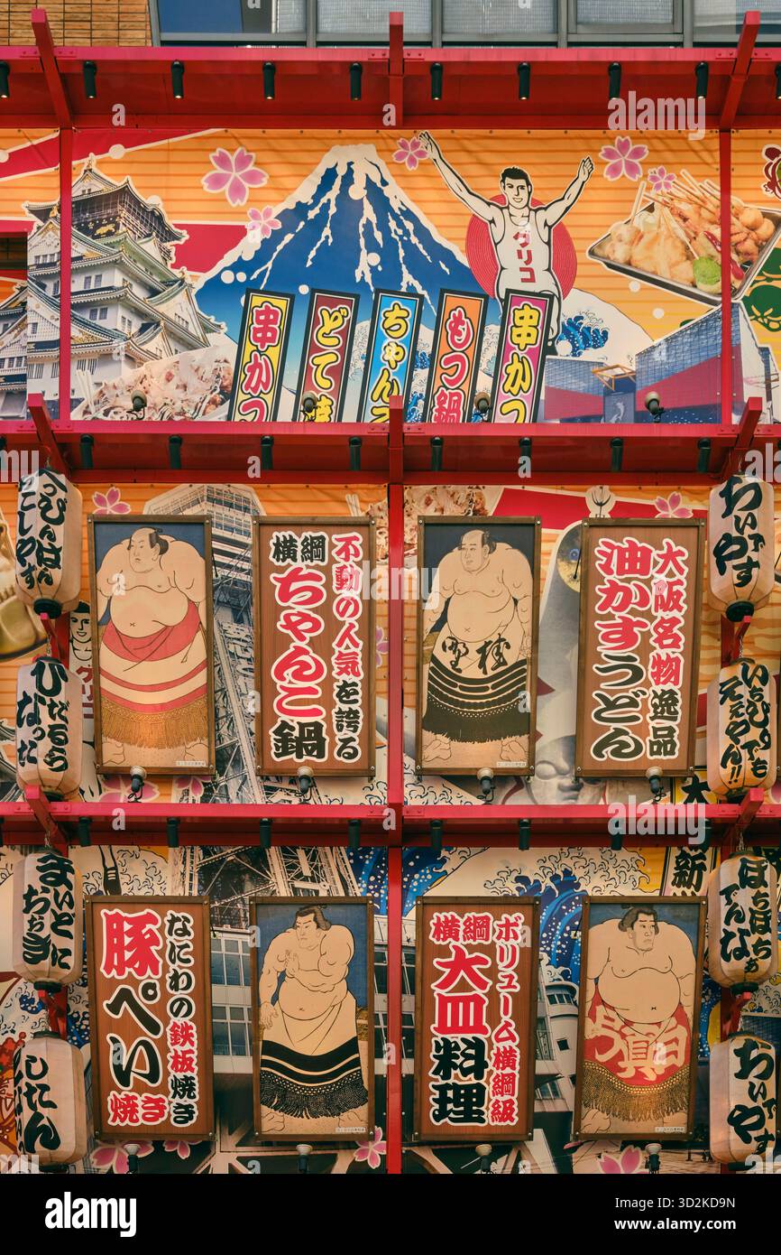 A collage featuring sumo fighters and the Glico Man decorates a restaurant front in the Shinsekai district, Osaka Stock Photo