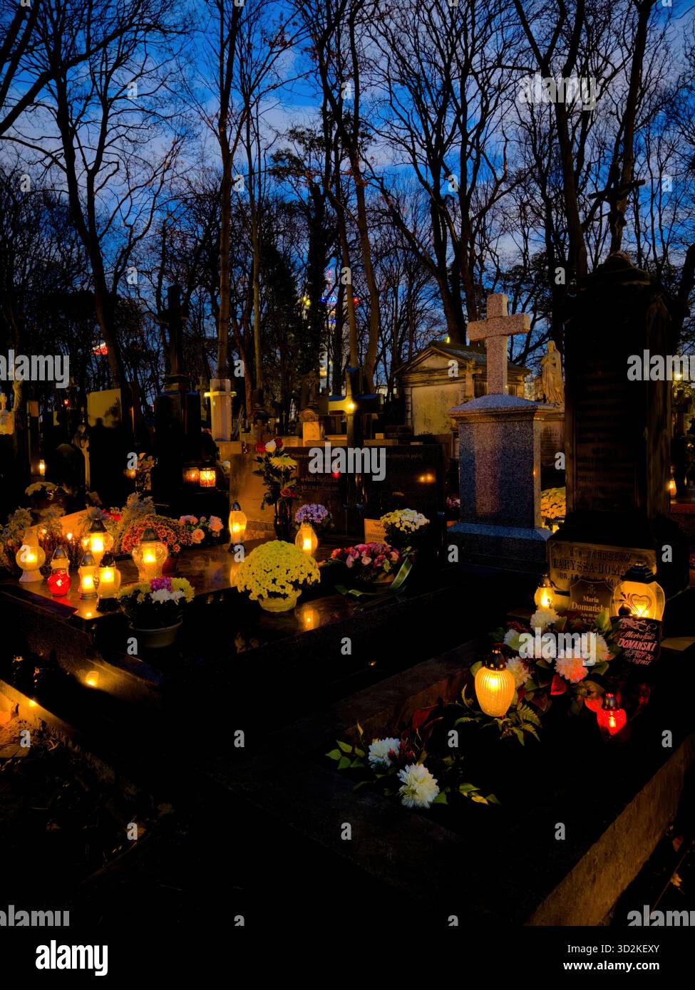 All Souls Day candles glowing among graves symbolize remembrance, spirituality, and eternal love. Memorial scene honoring deceased with flowers - Smartphone Captured Stock Image