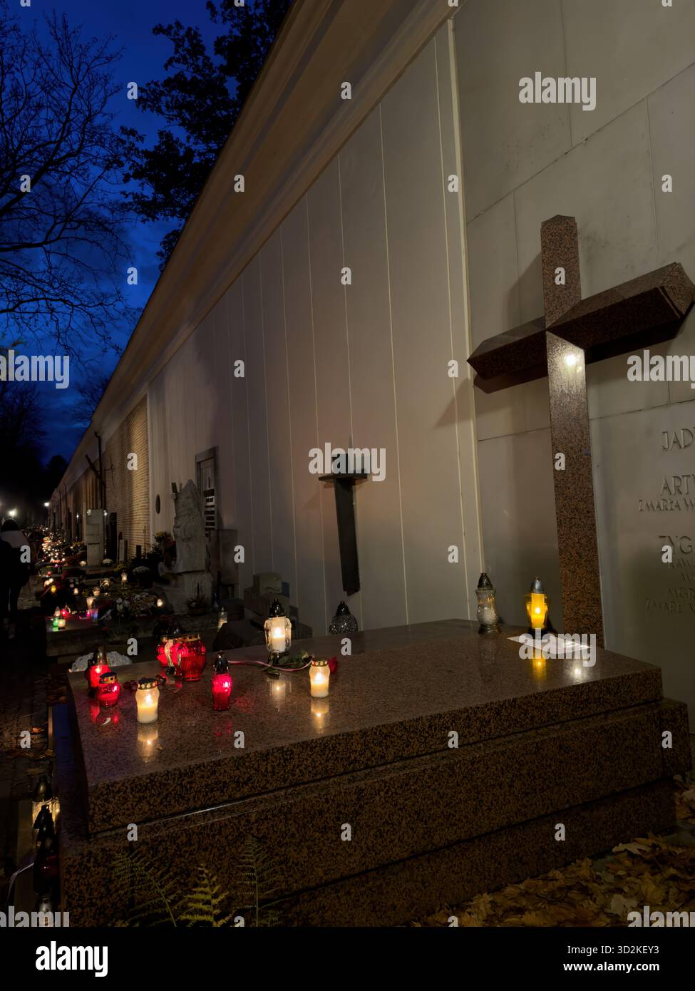 All Souls Day candles glowing among graves symbolize remembrance, spirituality, and eternal love. Memorial scene honoring deceased with flowers - Smartphone Captured Stock Image