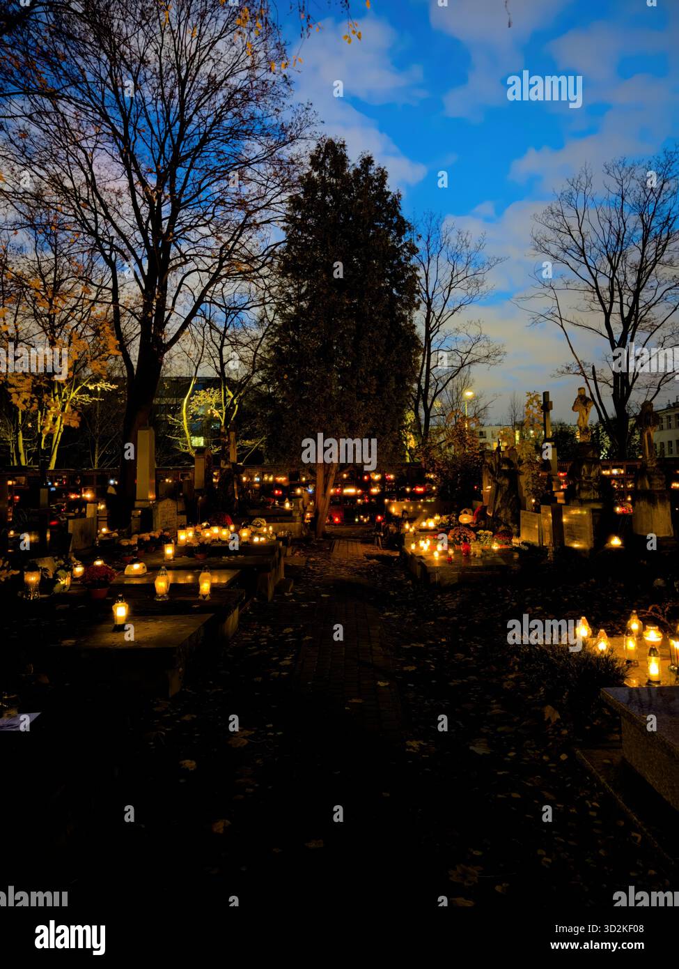 All Souls Day candles glowing among graves symbolize remembrance, spirituality, and eternal love. Memorial scene honoring deceased with flowers - Smartphone Captured Stock Image