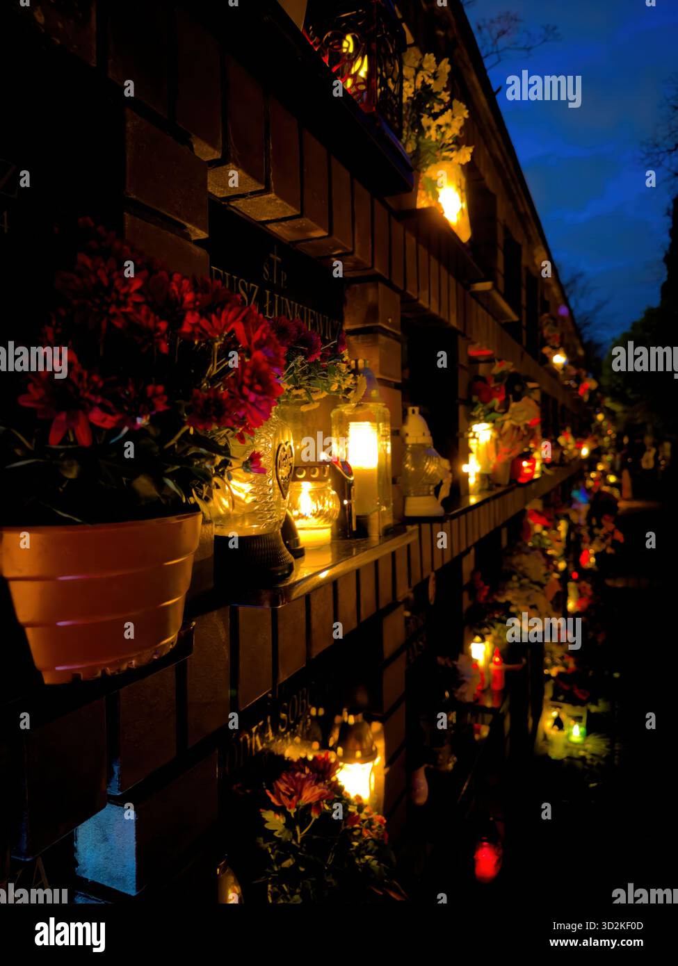 All Souls Day candles glowing among graves symbolize remembrance, spirituality, and eternal love. Memorial scene honoring deceased with flowers - Smartphone Captured Stock Image