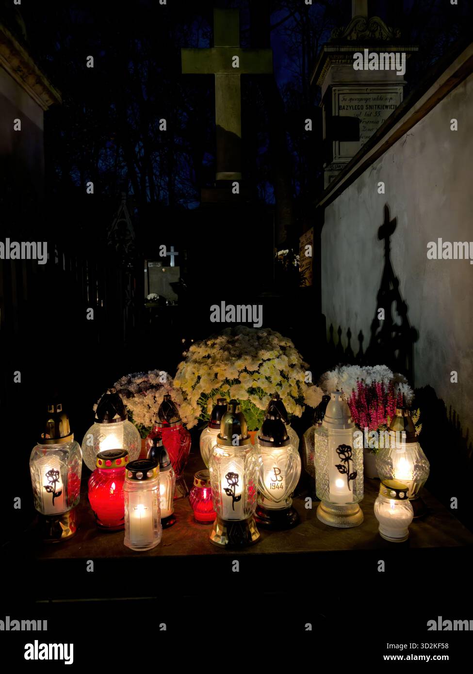 All Souls Day memorial filled with glowing candles and flowers represents remembrance, faith, and hope. Peaceful cemetery atmosphere people honor - Smartphone Captured Stock Image