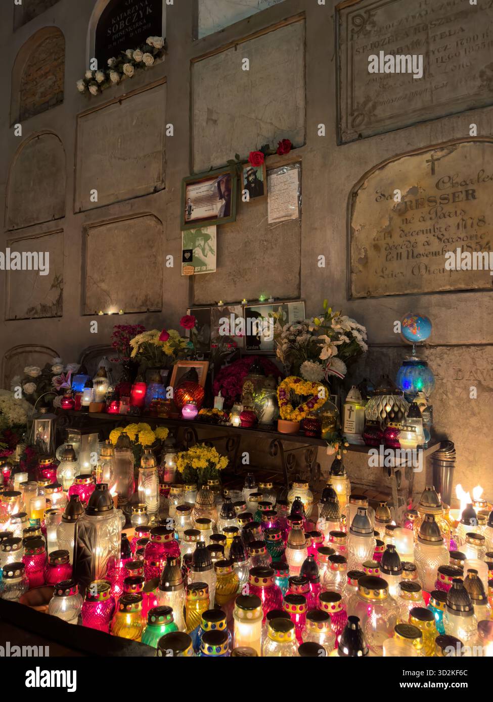 All Souls Day memorial filled with glowing candles and flowers represents remembrance, faith, and hope. Peaceful cemetery atmosphere people honor - Smartphone Captured Stock Image