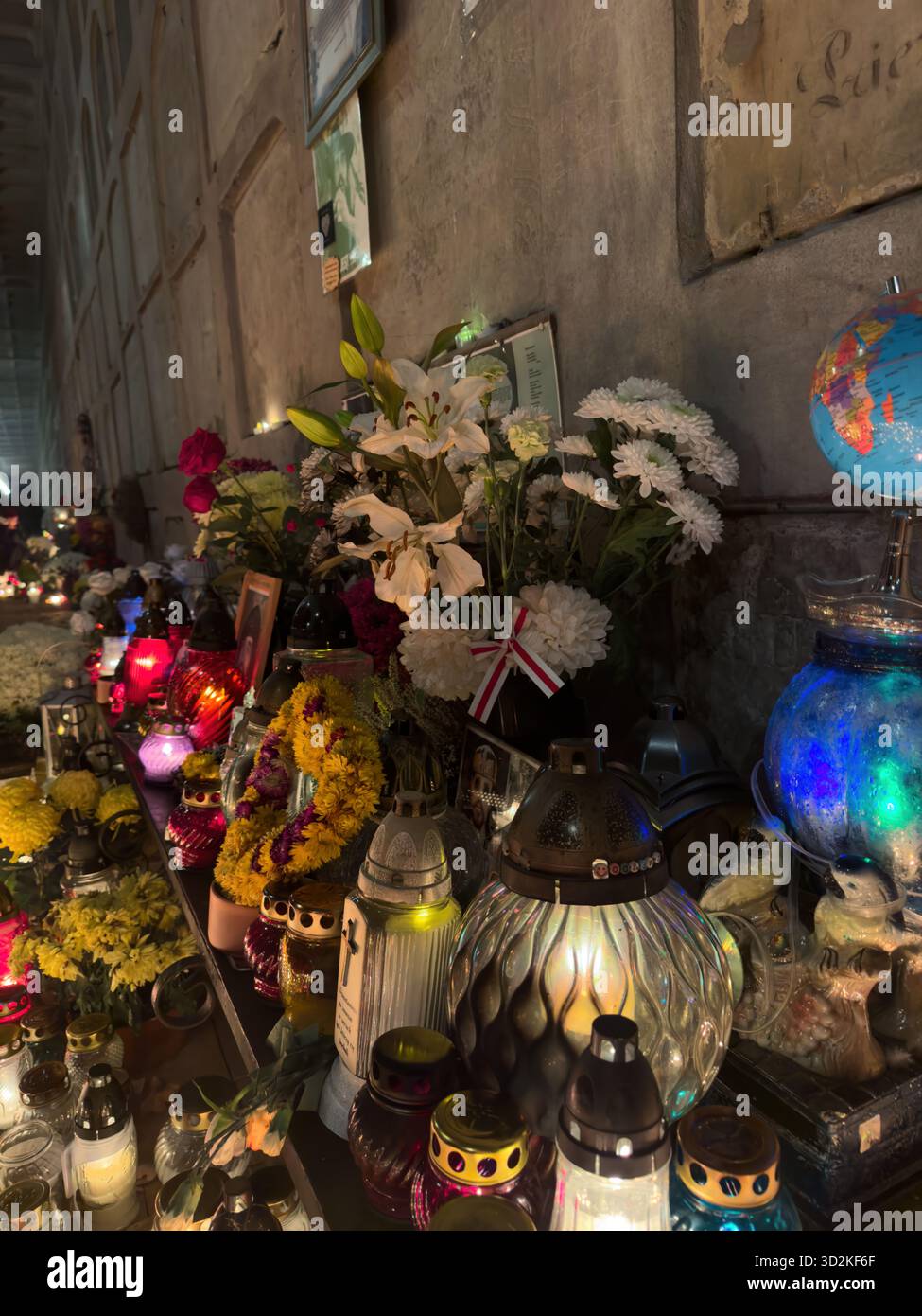 All Souls Day memorial filled with glowing candles and flowers represents remembrance, faith, and hope. Peaceful cemetery atmosphere people honor - Smartphone Captured Stock Image