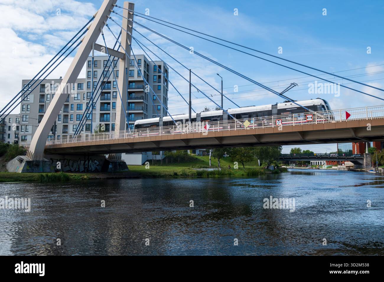 Tram passes a bridge over the Brda River, Bydgoszcz, Poland Stock Photo