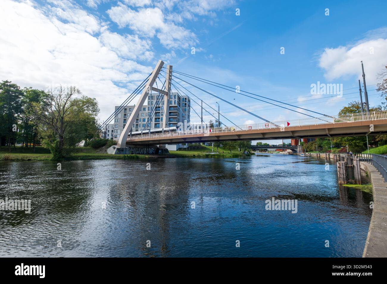 Tram passes a bridge over the Brda River, Bydgoszcz, Poland Stock Photo