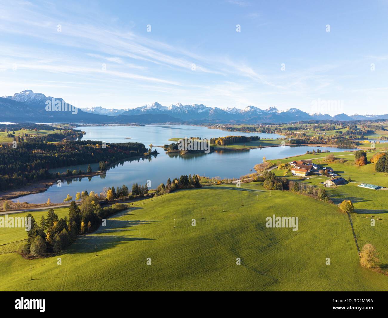 View of a lake surrounded by green hills and mountains under a clear blue sky, Illasbergsee, Forggensee, near Rosshaupten, Ostallgaeu, Allgaeu, Swabia Stock Photo