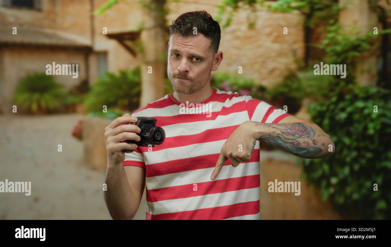 Young man tattoos pointing downward hi-res stock photography and images ...