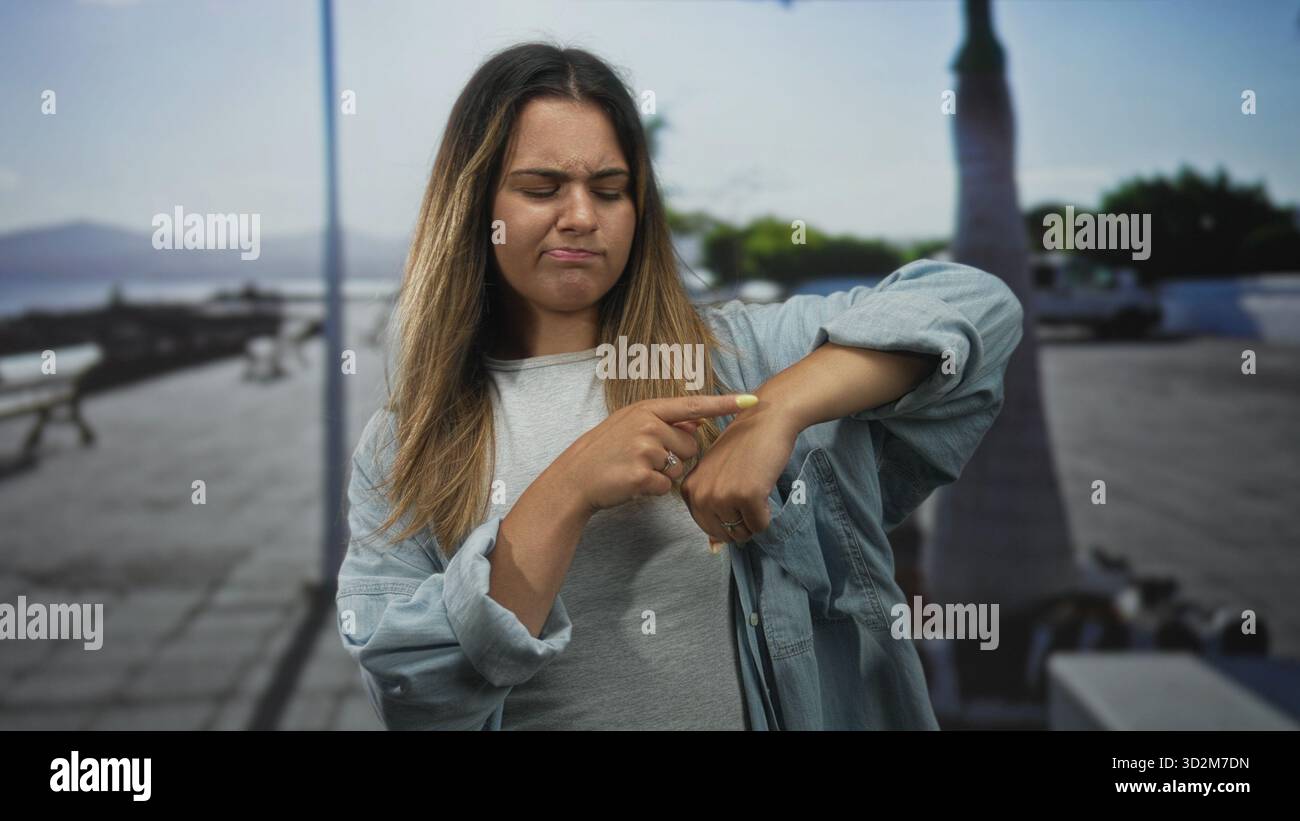 Woman points finger at chest on street promenade by the seaside, facing ...