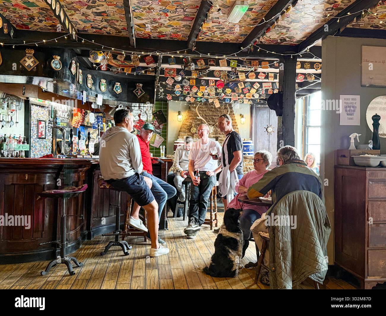 A relaxed local pub social scene in Minehead on the north coast in the county of Somerset in southwest England. - Smartphone Captured Stock Image