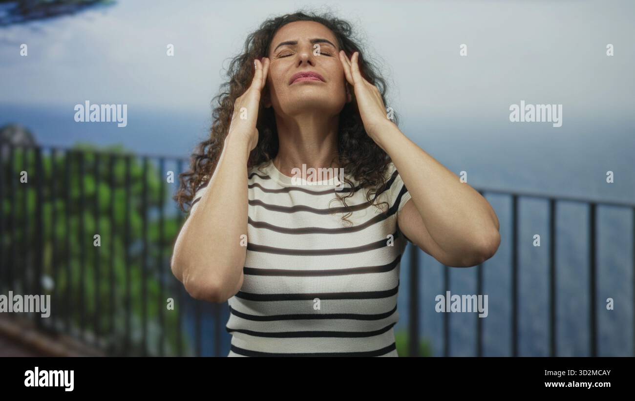 Woman presses temples hands beside hi-res stock photography and images ...