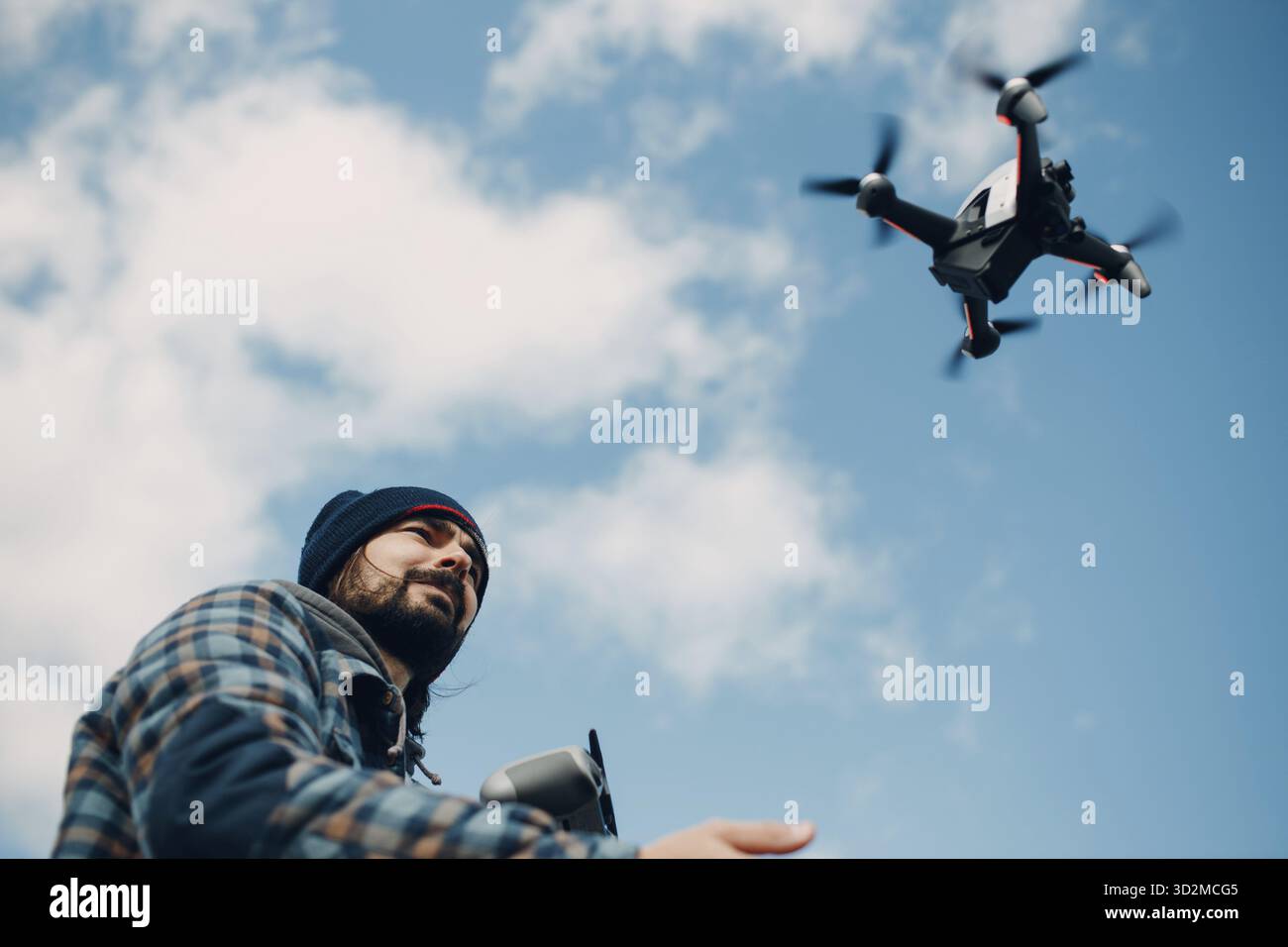 Man pilot Launches quadcopter drone from hand to sky flight Stock Photo