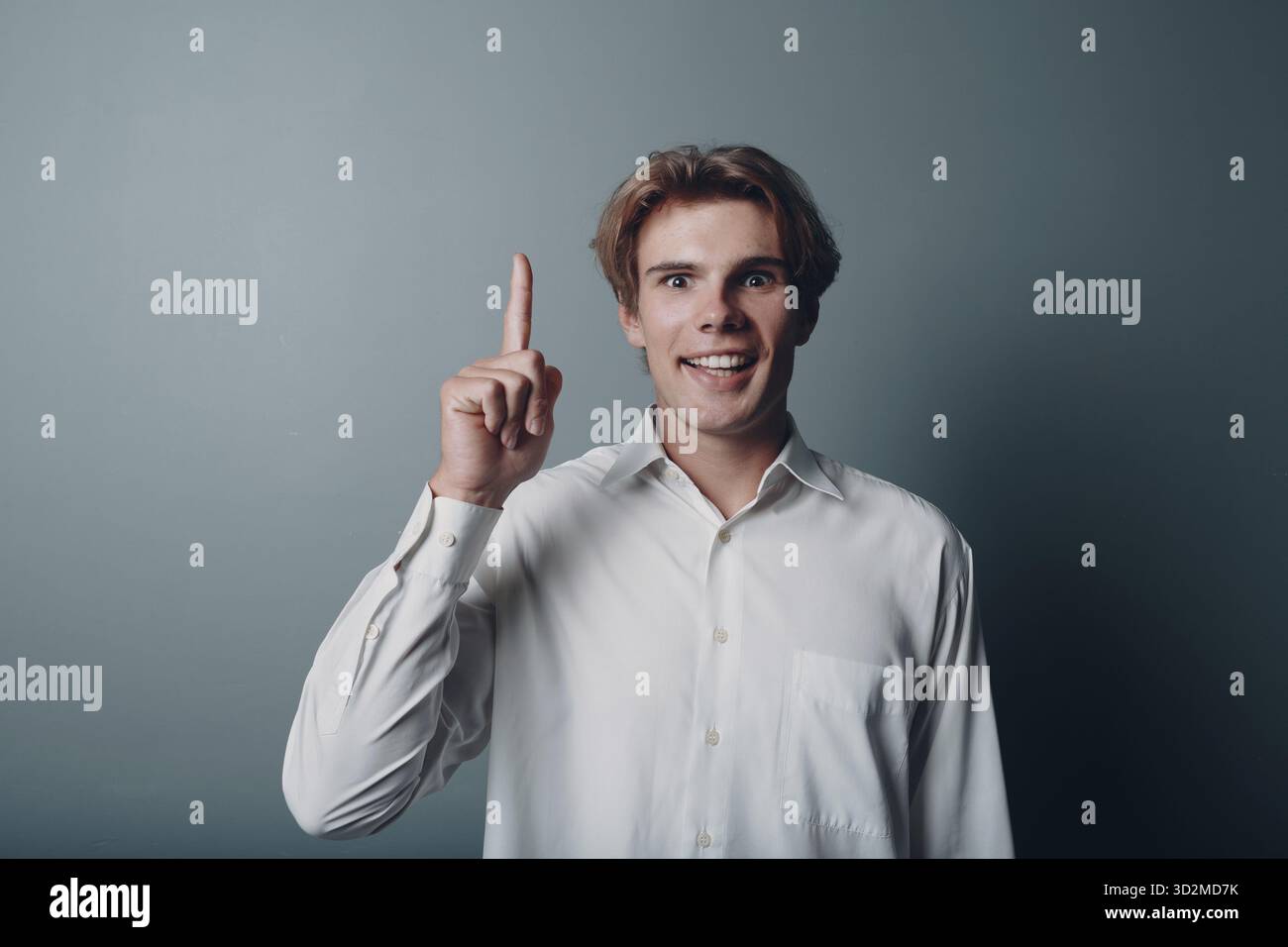 Young man pointing and forefinger index finger up Stock Photo