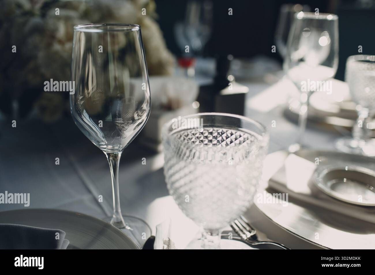 Beautiful shape empty wine glass on table in restaurant decor Stock Photo