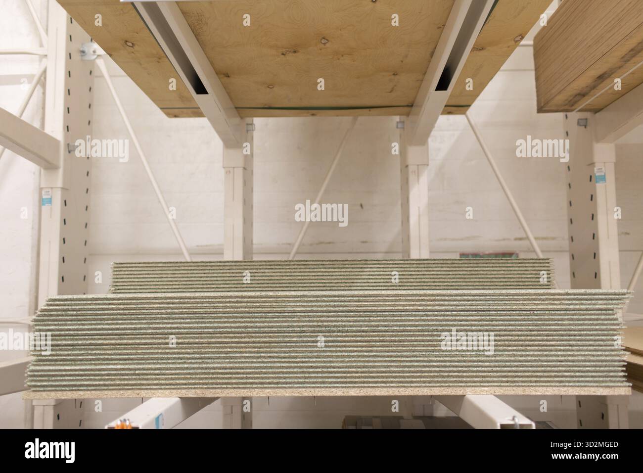 OSB wooden chipboard sheets stacked in store Stock Photo
