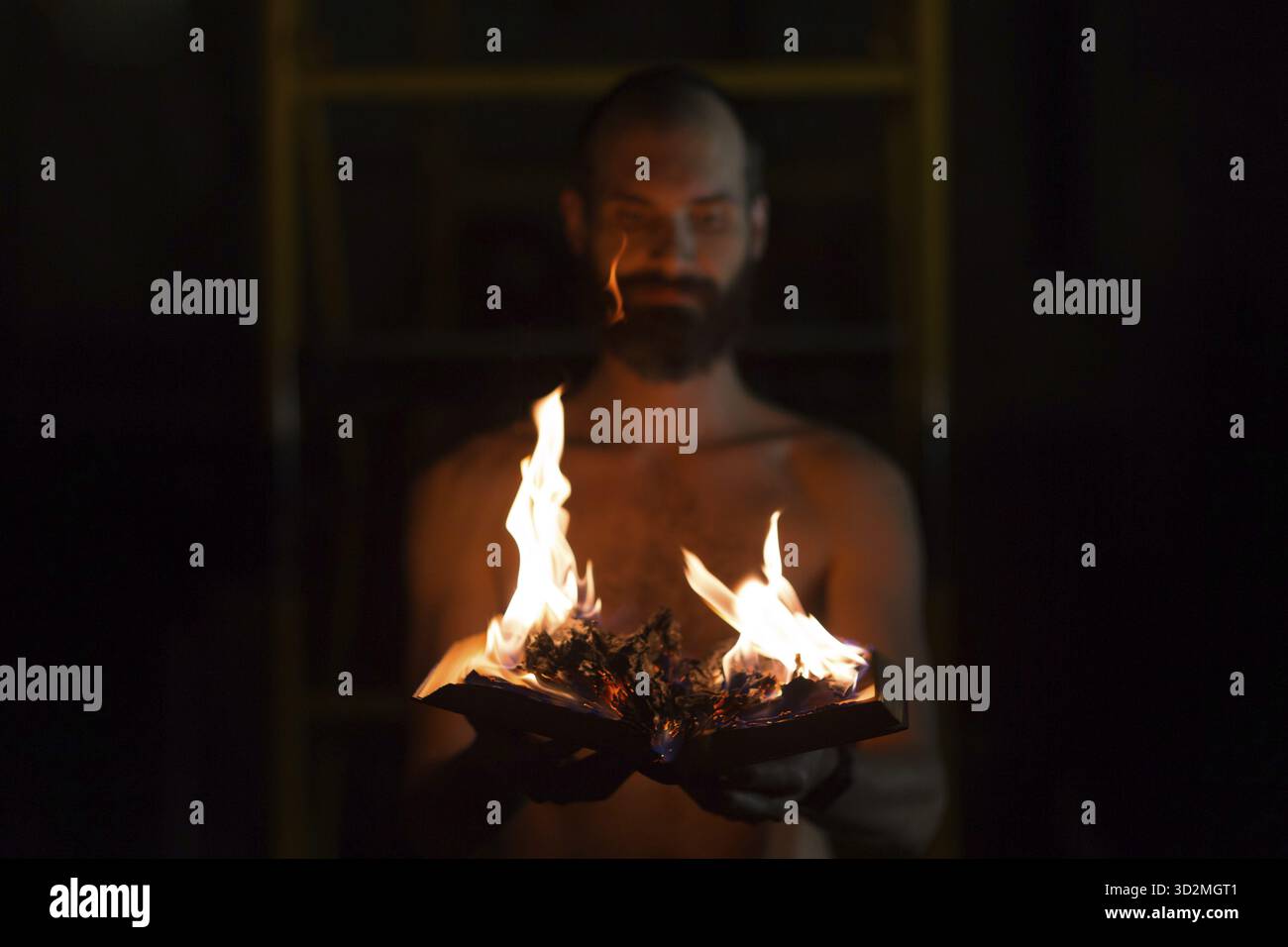 Man hold burning book in his hands Stock Photo