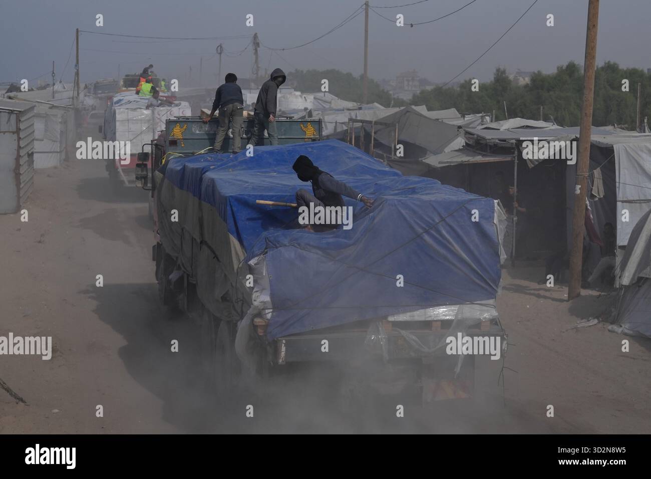 Trucks carrying aid drive through Khan Younis, southern Gaza Strip ...