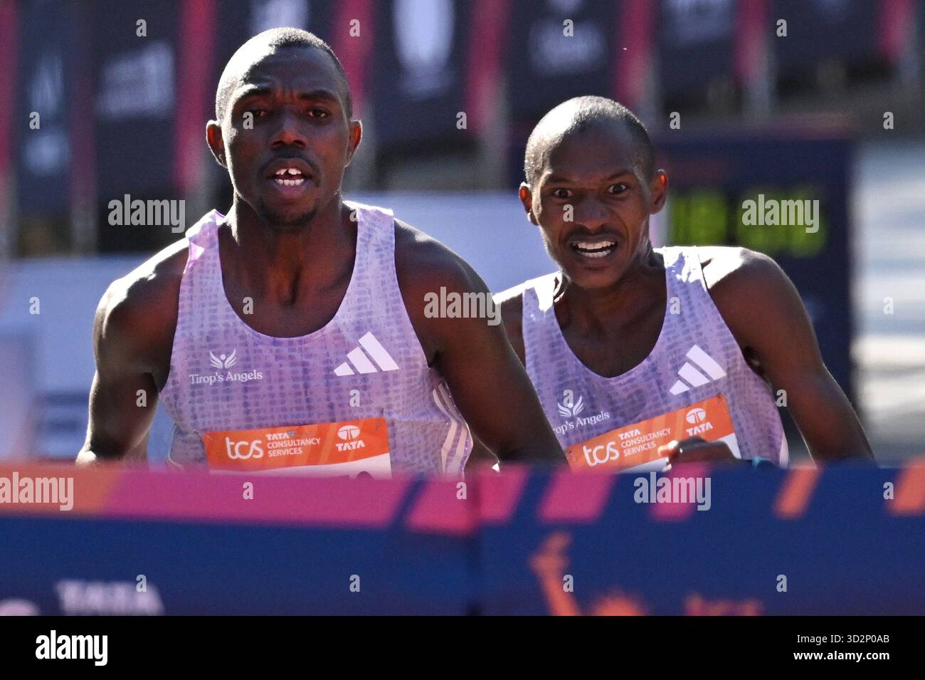 (L-R) Benson Kipruto and Alexander Mutiso of Kenya cross the finish ...