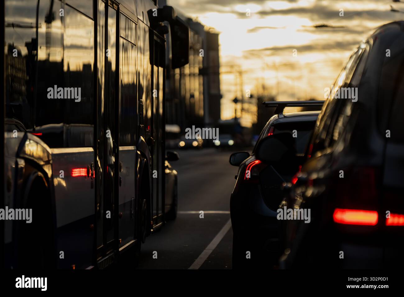 Evening traffic congestion in Riga with cars and public bus reflecting ...