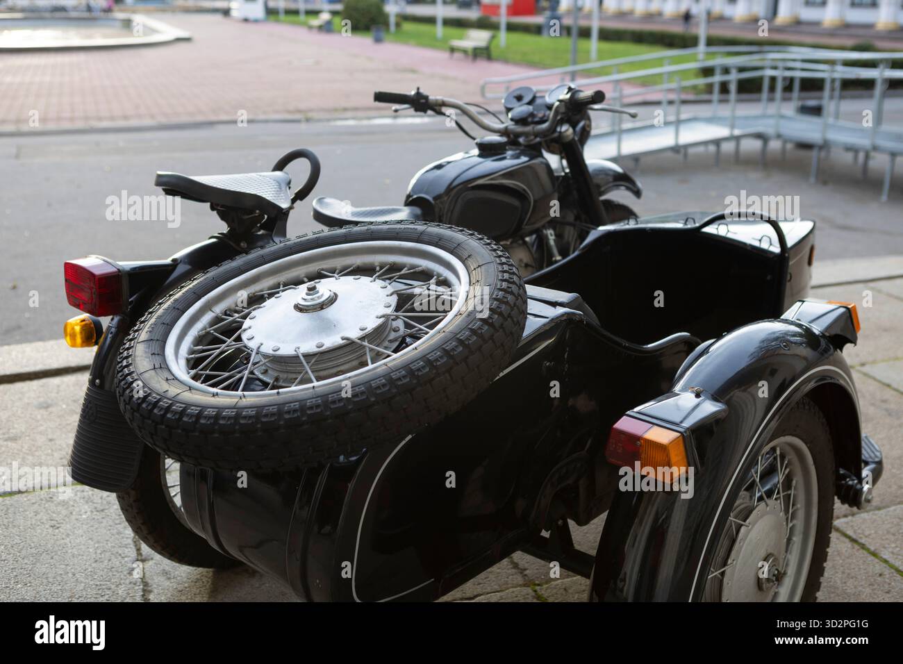An old vintage black motorcycle with a sidecar stands proudly at an ...