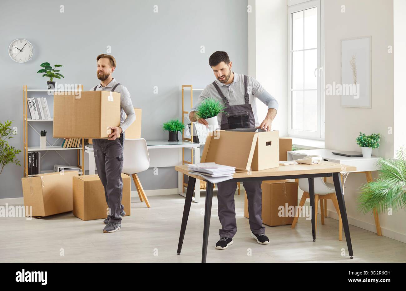 Two Movers Relocating With Boxes From Office Or Home Stock Photo