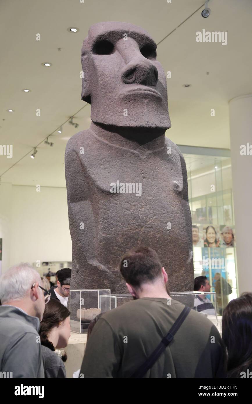 Visitors study a basalt-made statue from the Easter Island displayed at ...