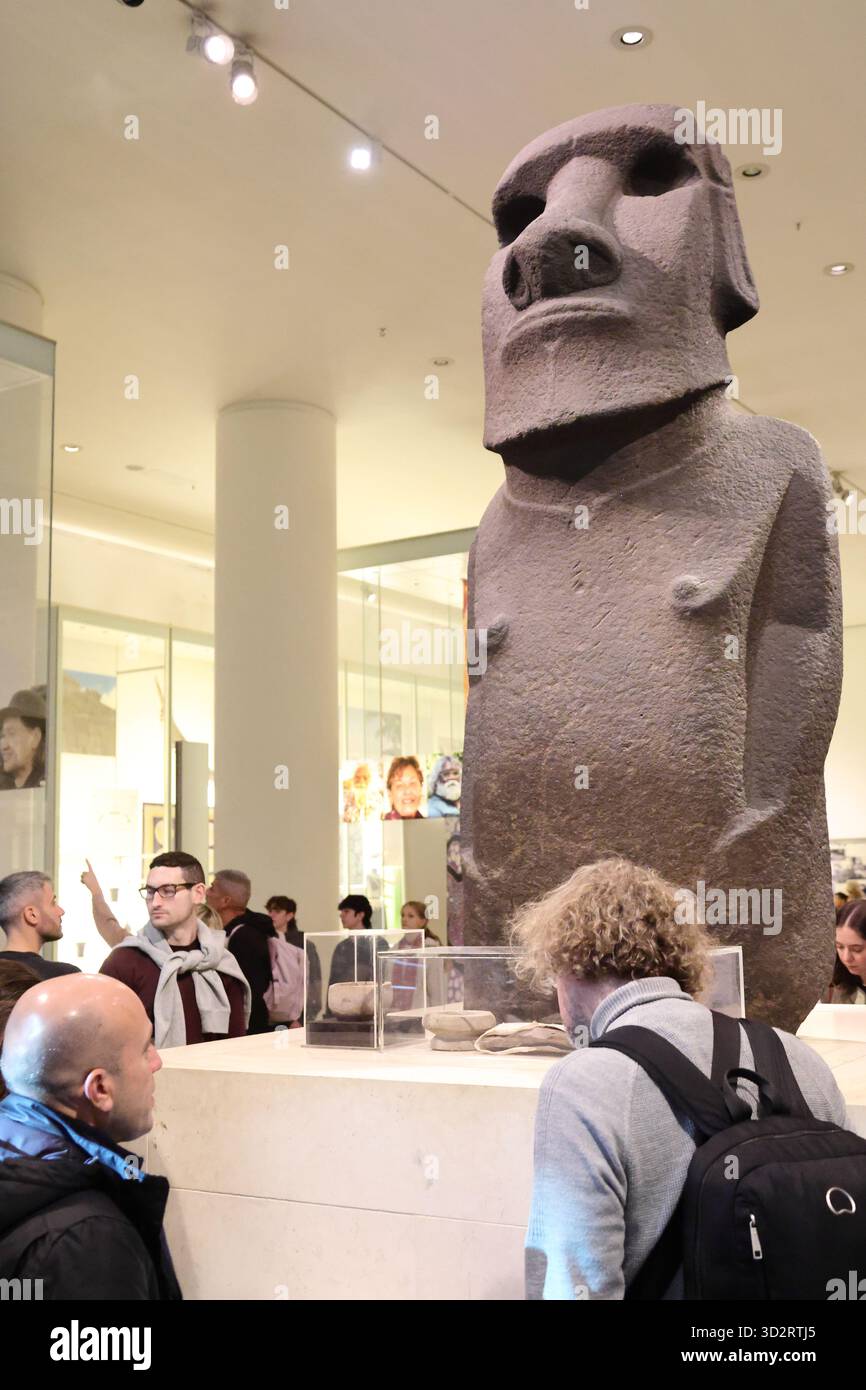 Visitors study a basalt-made statue from the Easter Island displayed at ...