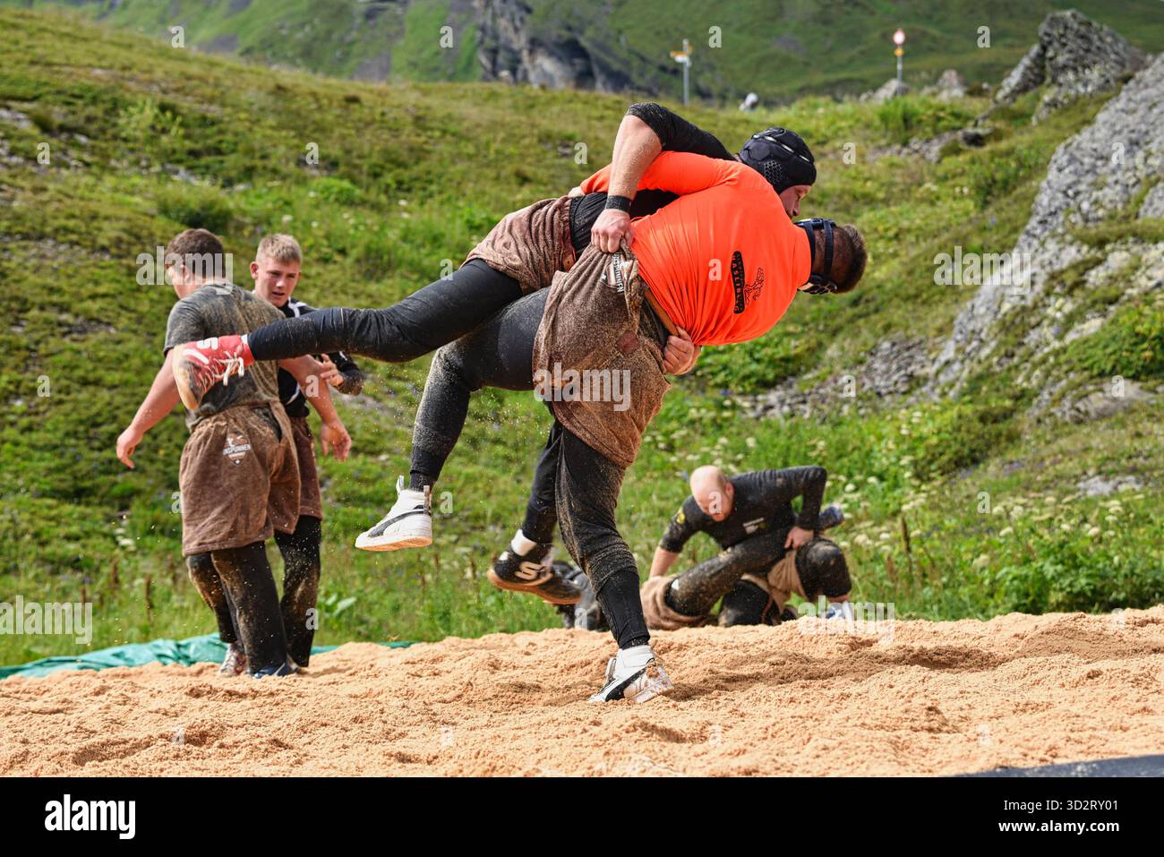 Swiss folk wrestling, Schwingen, being practiced outside by big strong men wearing special leather shorts swinging opponent, Grindelwald, Switzerland Stock Photo