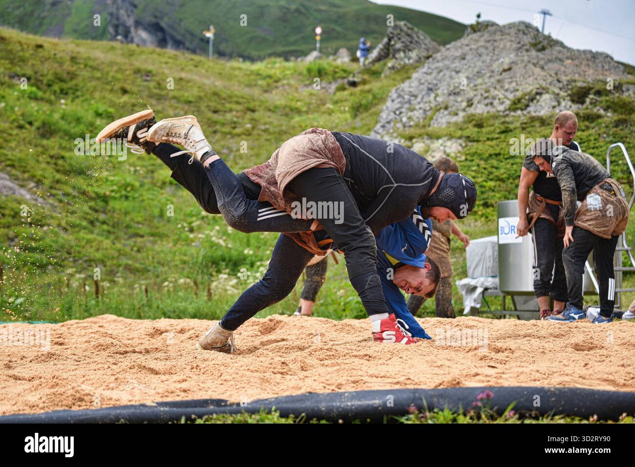 Swiss folk wrestling, Schwingen, being practiced outside by big strong men wearing special leather shorts swinging opponent, Grindelwald, Switzerland Stock Photo