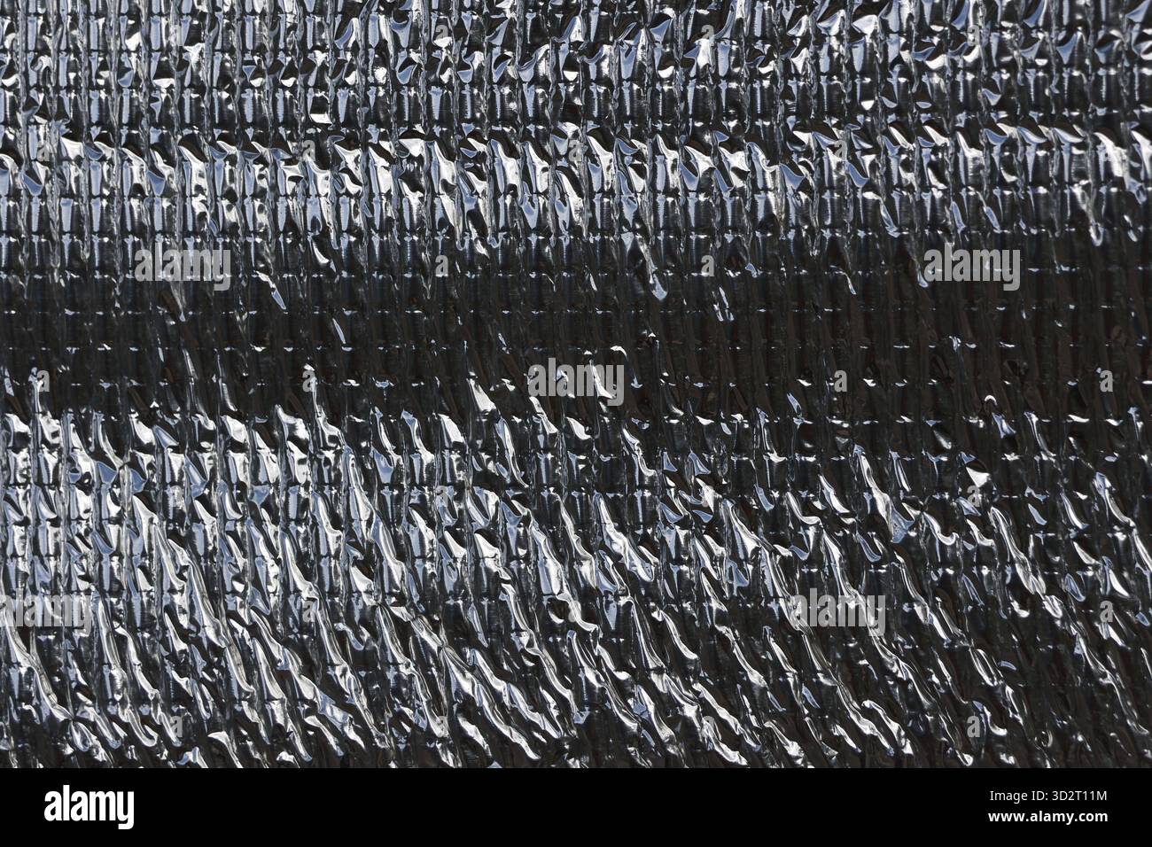 Close up texture of silver metallic heat protection sheet background. This material offers insulation with reflective surface for industrial and futur Stock Photo