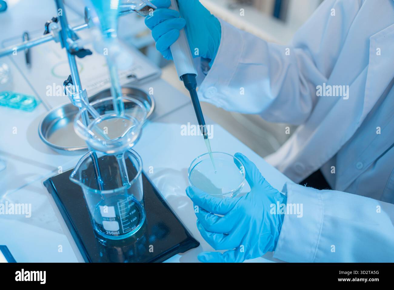 Two female scientists in white lab coats working together in a bright ...