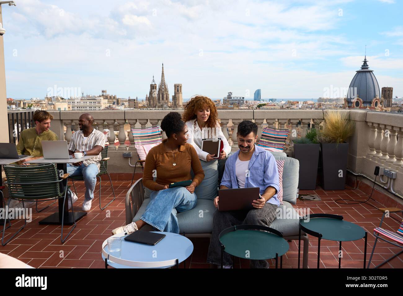 Diverse business team collaborating on barcelona rooftop Stock Photo