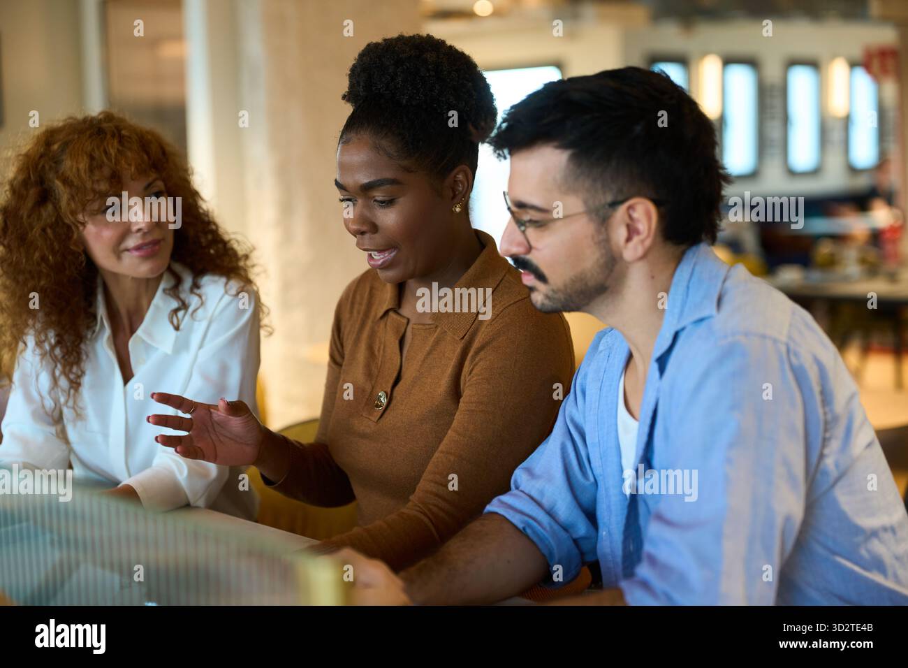 Diverse business team collaborating during office discussion Stock Photo