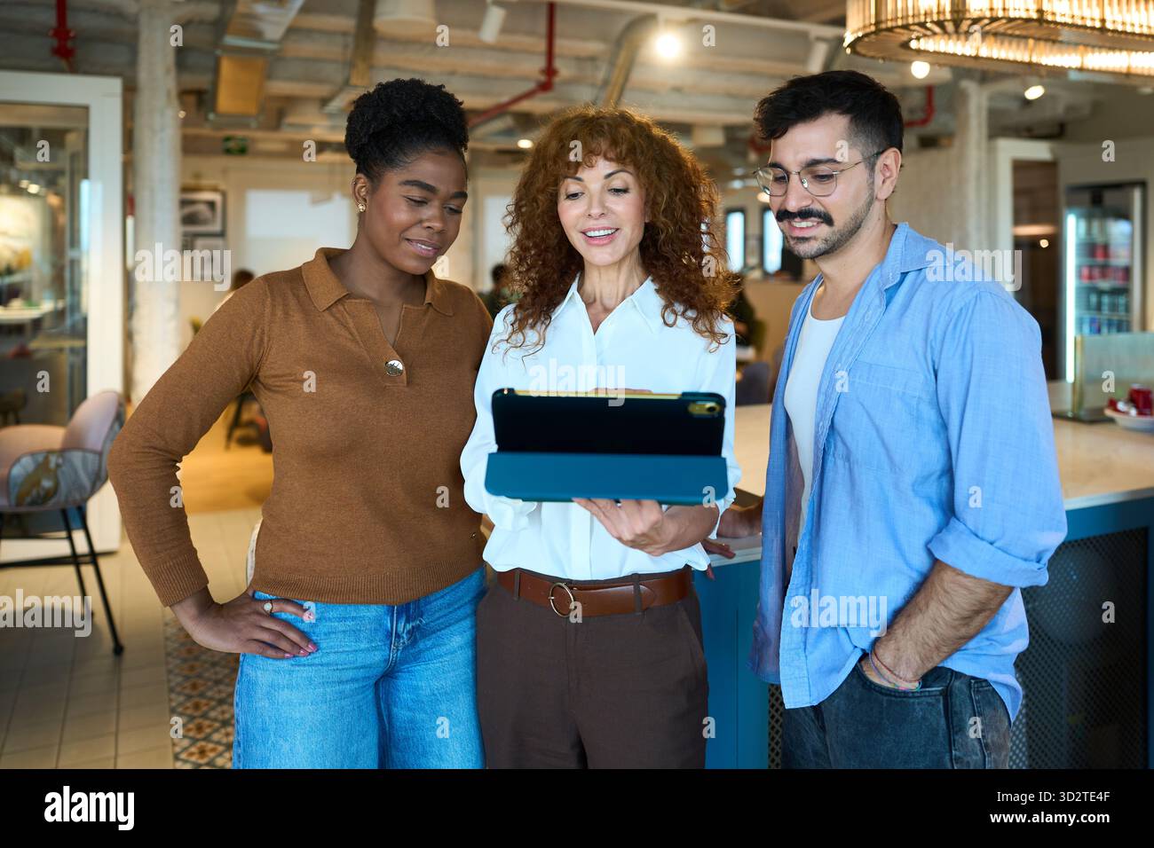 Diverse business team collaborating using digital tablet Stock Photo