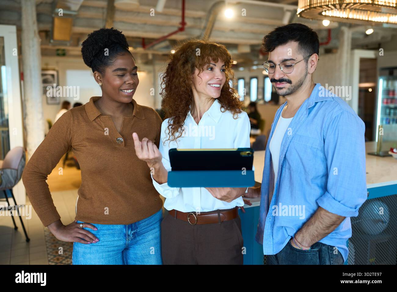 Diverse business team collaborating using digital tablet Stock Photo