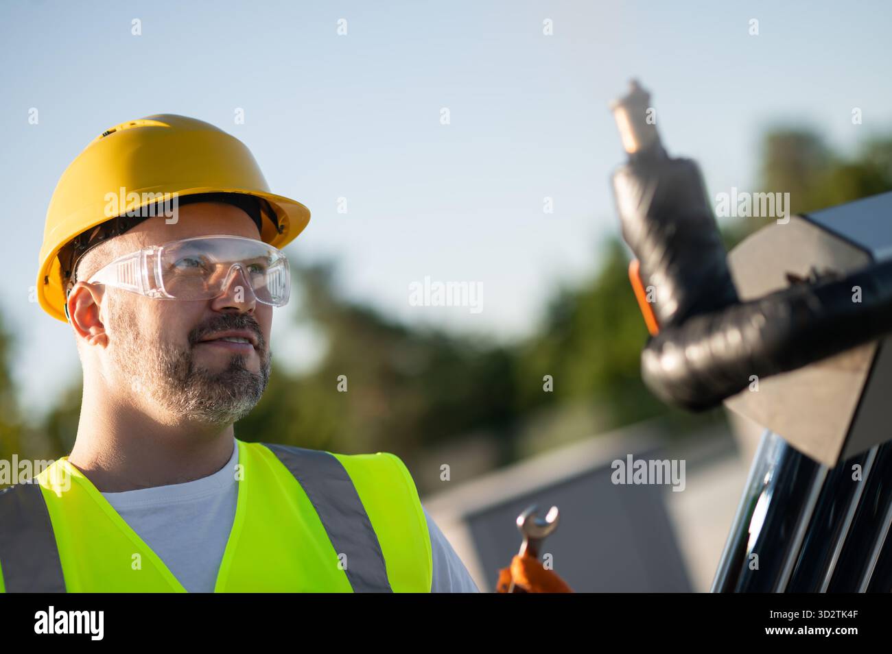 Professional technician working on solar heating structure Stock Photo