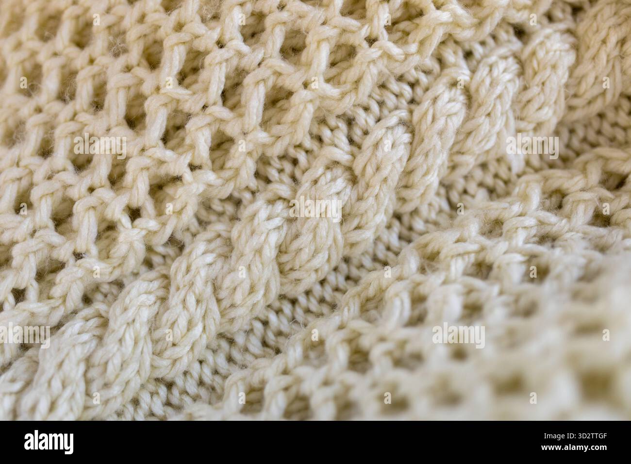 Cable knit sweater in cream wool Stock Photo