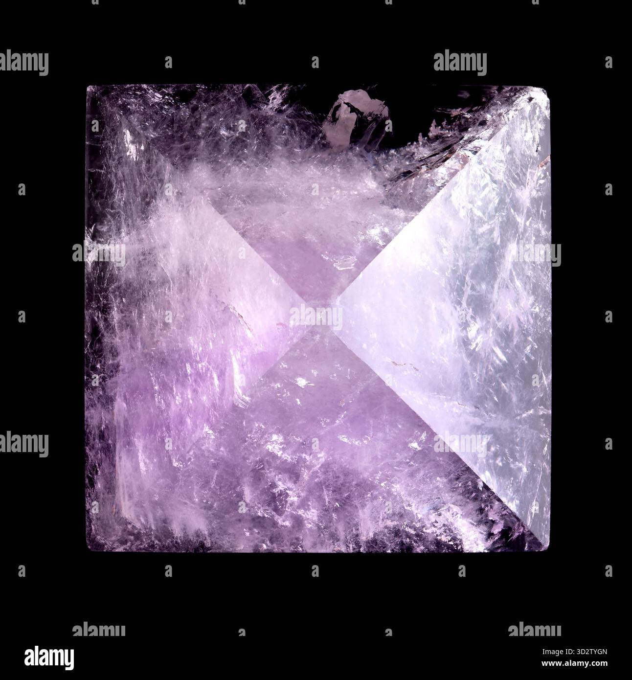 Amethyst pyramid, close-up, from above, isolated, on black background. Cut and polished semi-precious stone, with exact apex. Stock Photo
