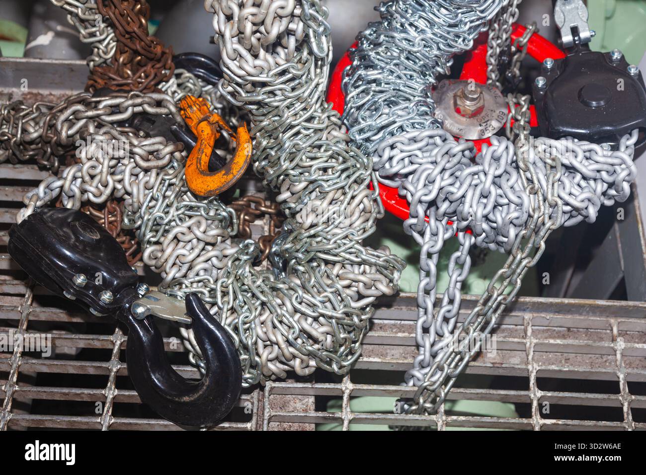 Chain hoists for lifting weights in a workshop close-up Stock Photo