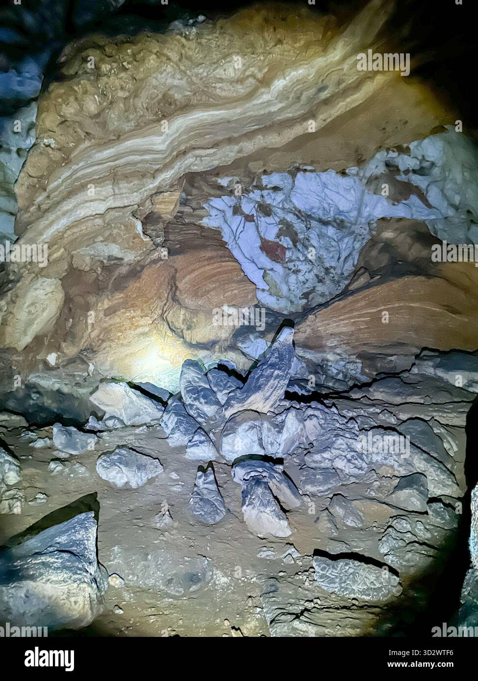 Detailed view of layered rock formations and mineral textures inside the Ice Cave in Uvac Canyon, Serbia, illuminated by soft cave light. - Smartphone Captured Stock Image
