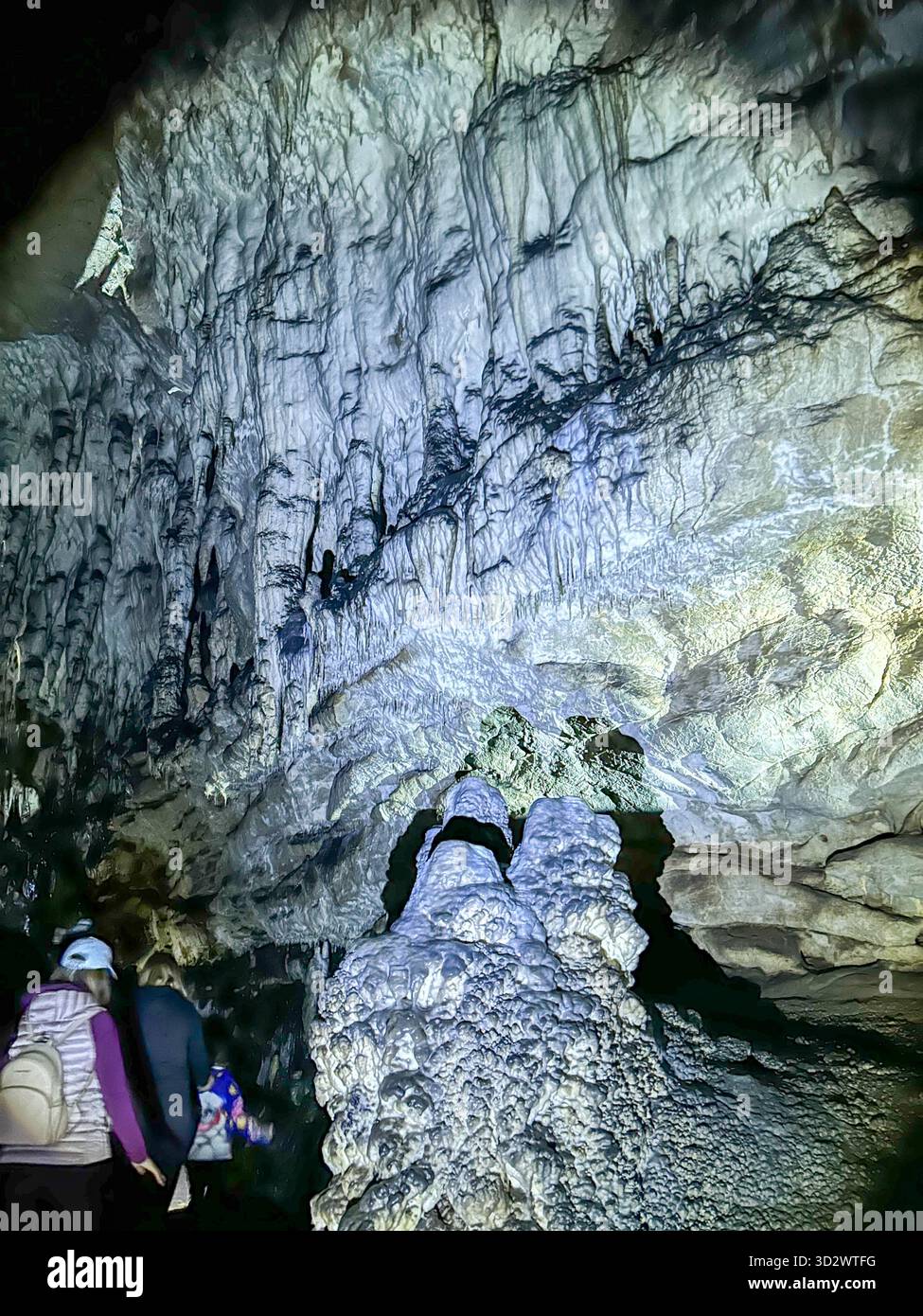 Stunning view inside the Ice Cave in Uvac Canyon, Serbia, showcasing unique stalactites, stalagmites, and natural limestone formations illuminated by - Smartphone Captured Stock Image